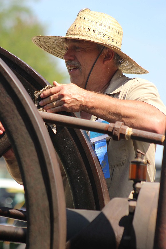 Batesville resident Steve Schantz prepares a 1915 Reid engine for use Friday afternoon. (The Commercial Review/Bailey Cline)