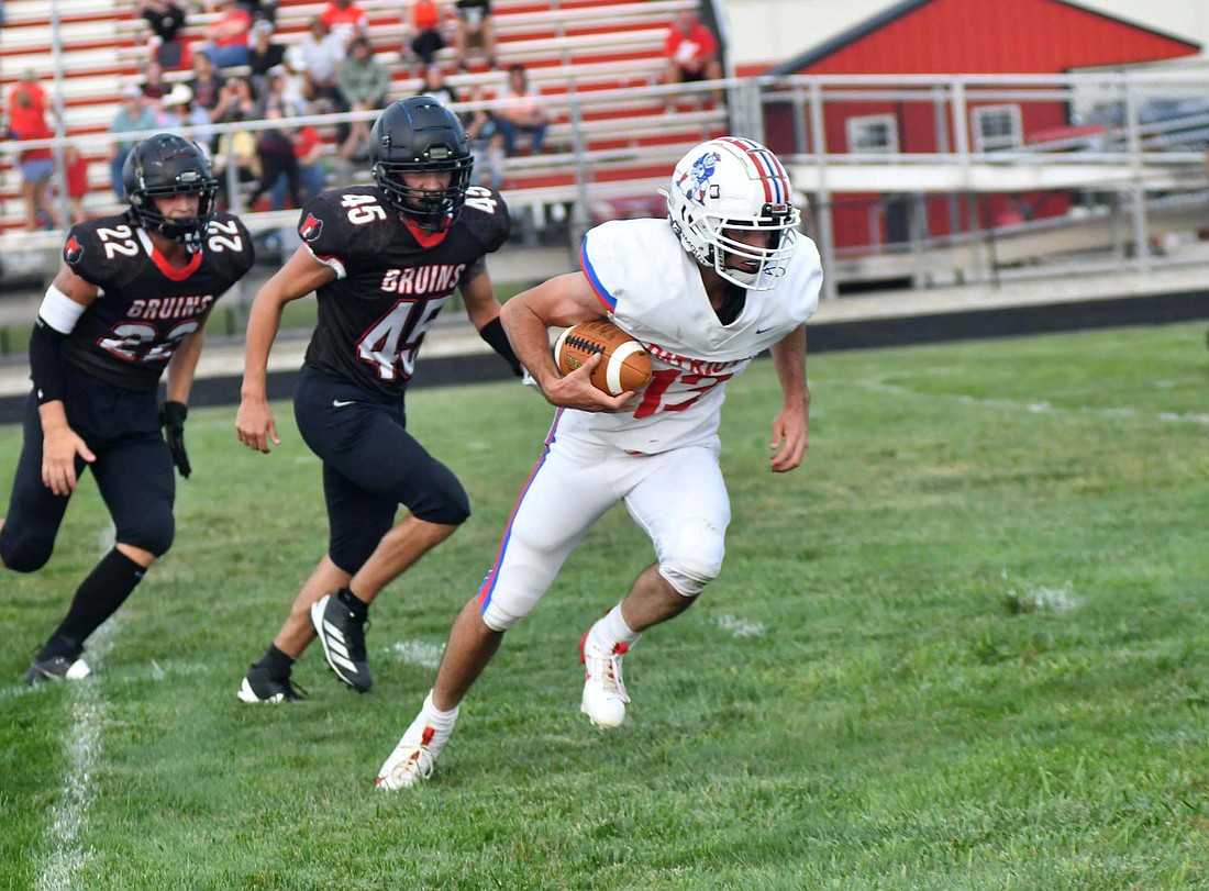 Jay County High School senior Lucas Strait heads toward the end zone after picking up a punt he blocked during the Patriots’ 49-0, season-opening victory Friday over the host Blackford Bruins. He went the distance for his second career touchdown as JCHS led 21-0 less than 10 minutes into the game. (The Commercial Review/Ray Cooney)