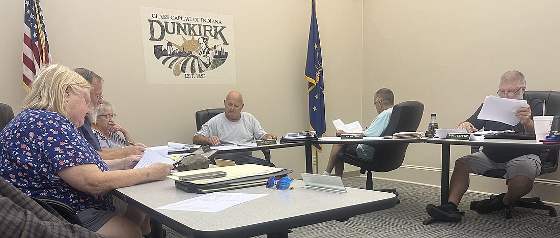 Dunkirk City Council members, from left, Donna Revolt, Jesse Bivens and Christy Curts, Mayor Jack Robbins, and council members Dan Watson and Randy Murphy review paperwork Monday evening while considering employee raises for 2025. Council ultimately settled on 5% raises for most employees and 10% raises for most supervisors. (The Commercial Review/Ray Cooney)