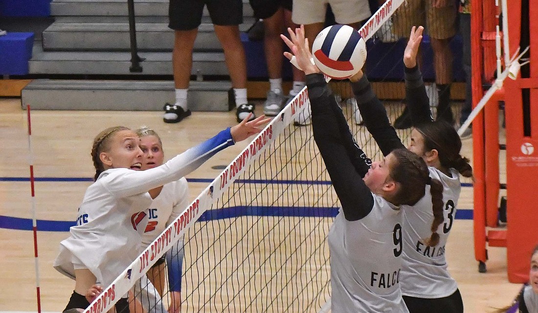 Jay County High School’s Mya Kunkler hits around the block attempts from Auden Hummel (9) and Jasmine Rheinhart (3) of Winchester in the Patriots’ win on Tuesday. Kunkler had nine kills in the match, trailing only Hummel (13) and JCHS sophomore Brenna Schmiesing (11) and tying Rheinhart in the 25-17, 20-25, 25-17, 25-10 victory. (The Commercial Review/Andrew Balko)