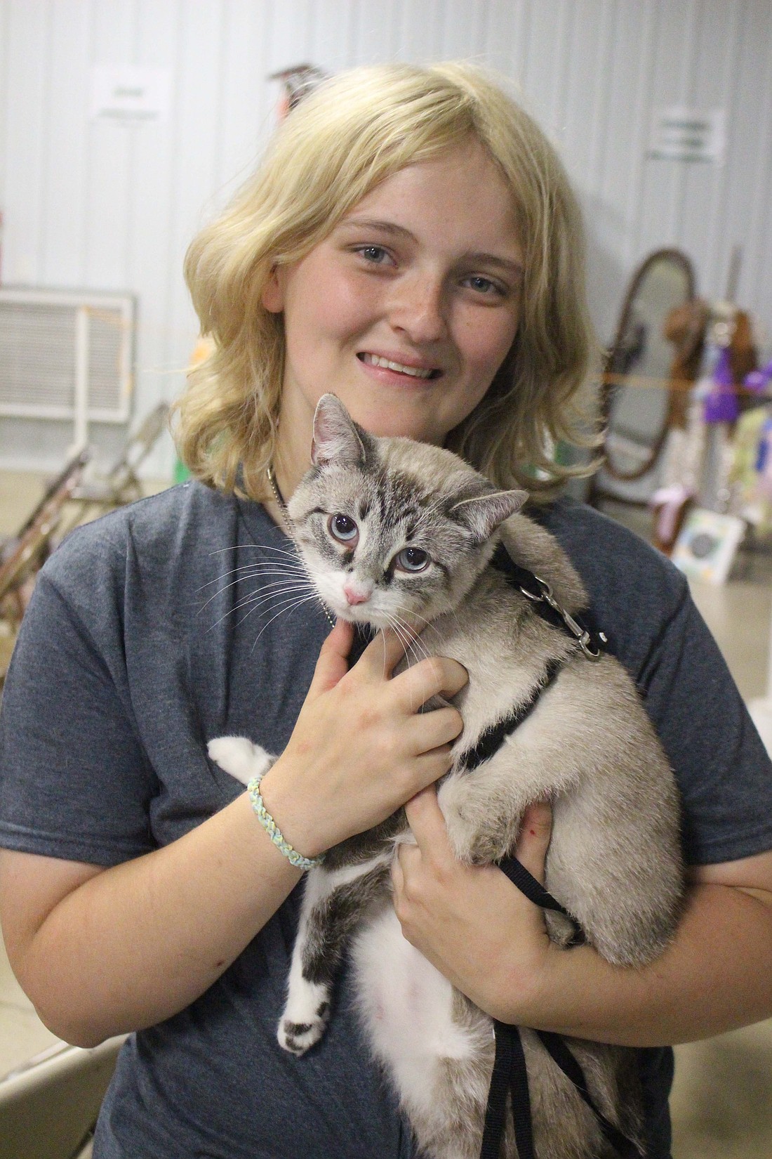 Alivia Toney, 15, holds her cat, Pandora, after earning the titles of senior and master class showman at the Jay County 4-H Cat Show on July 8. (The Commercial Review/Bailey Cline)