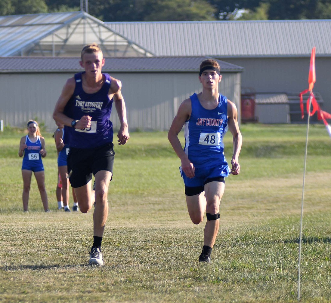 Fort Recovery High School’s Evan Evers (left) and Jay County’s Cooper Glentzer (48) start sprinting to the finish in a fight for seventh place. (The Commercial Review/Andrew Balko)