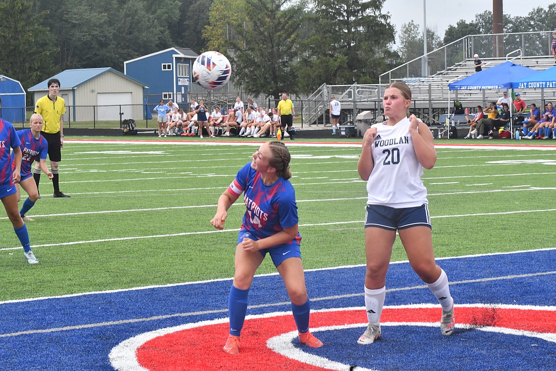 Jay County High School senior Morgan DeHoff prepares to take a header off of a corner kick from Raylin Hummer during the Patriots’ 4-1 win over Woodlan on Saturday. DeHoff had two goals and an assist in the match to help Jay move to 2-0 in ACAC play. (The Commercial Review/Andrew Balko)