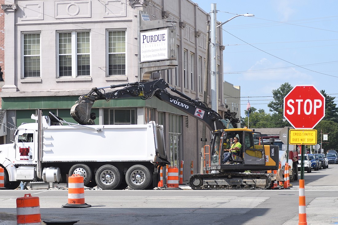 A crew from Brooks Construction of Fort Wayne works to dig out a portion of the street/sidewalk at the intersection of Meridian and Walnut streets in Portland in front of the Jay County Purdue Extension office. Mayor Jeff Westlake said at Monday’s city council meeting that the paving portion of the project is expected to begin Sept. 23. (The Commercial Review/Ray Cooney)