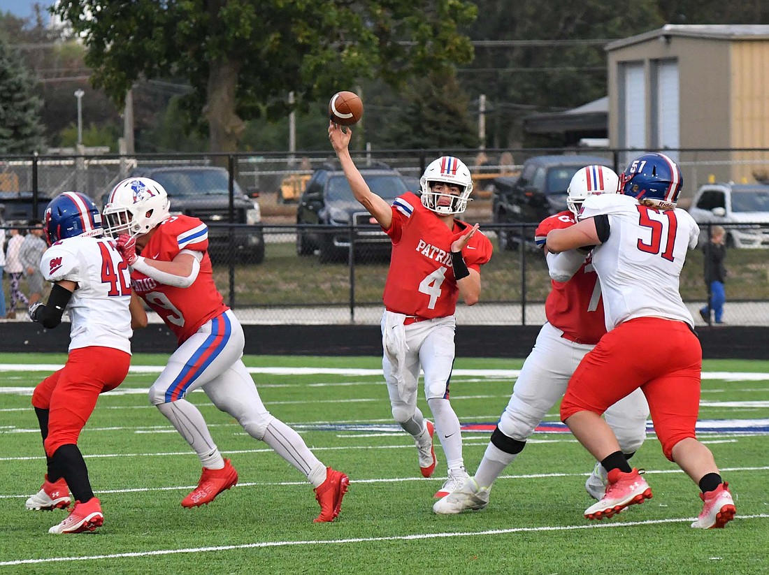 Jay County High School senior Sean Bailey (4) slings a pass while Leighton Brown (9) and Alejandro Ruiz (68) block for him. Bailey led the JCHS offense with 175 passing yards and three touchdowns in its 47-0 beating of Southern Wells on Friday. (The Commercial Review/Andrew Balko)