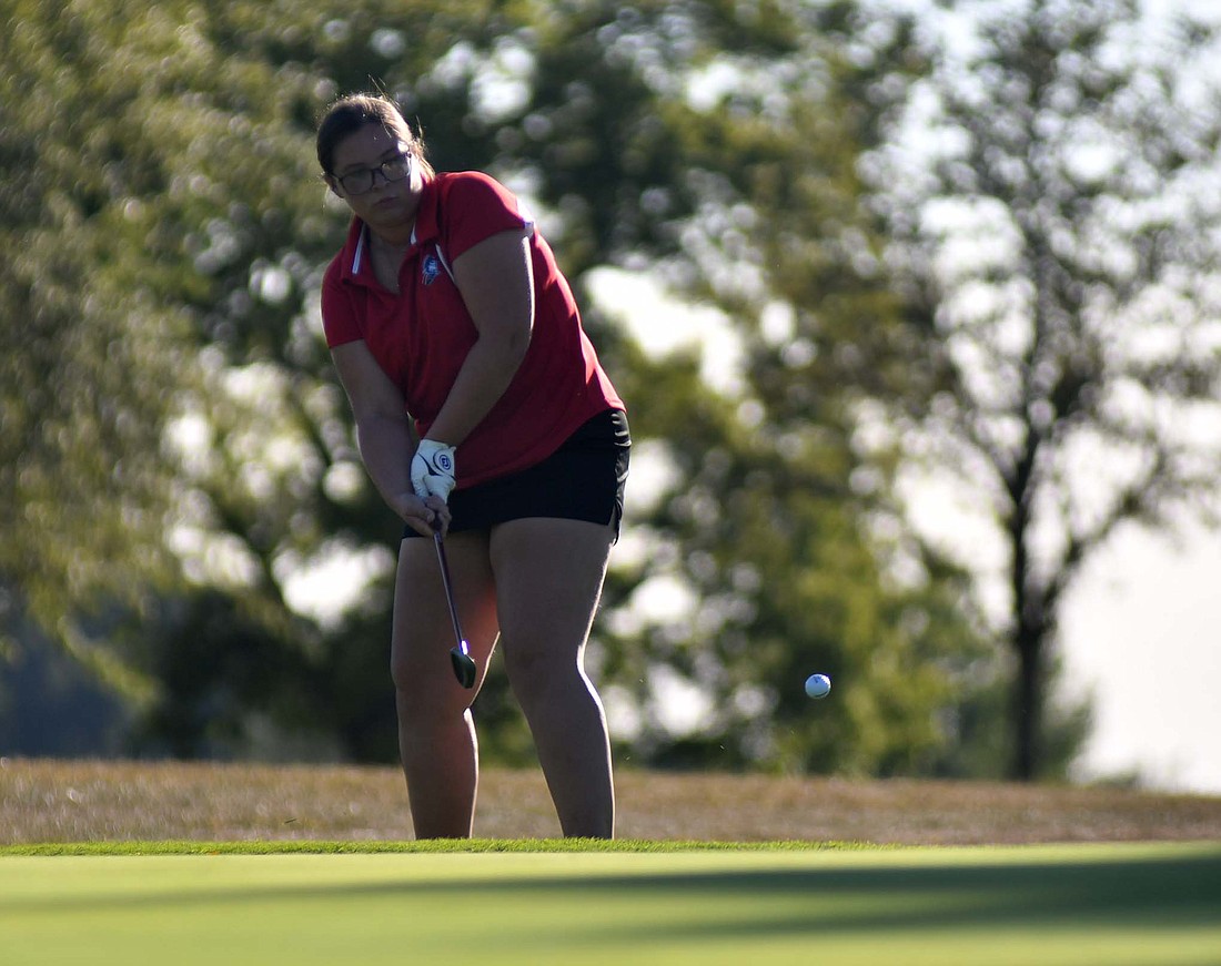 Jay County High School sophomore Erin Aker chips onto the eighth green at Hickory Hills Golf Club on Monday’s 195-202 loss to Monroe Central. Aker shot a career-best 51, shaving off seven strokes. (The Commercial Review/Andrew Balko)