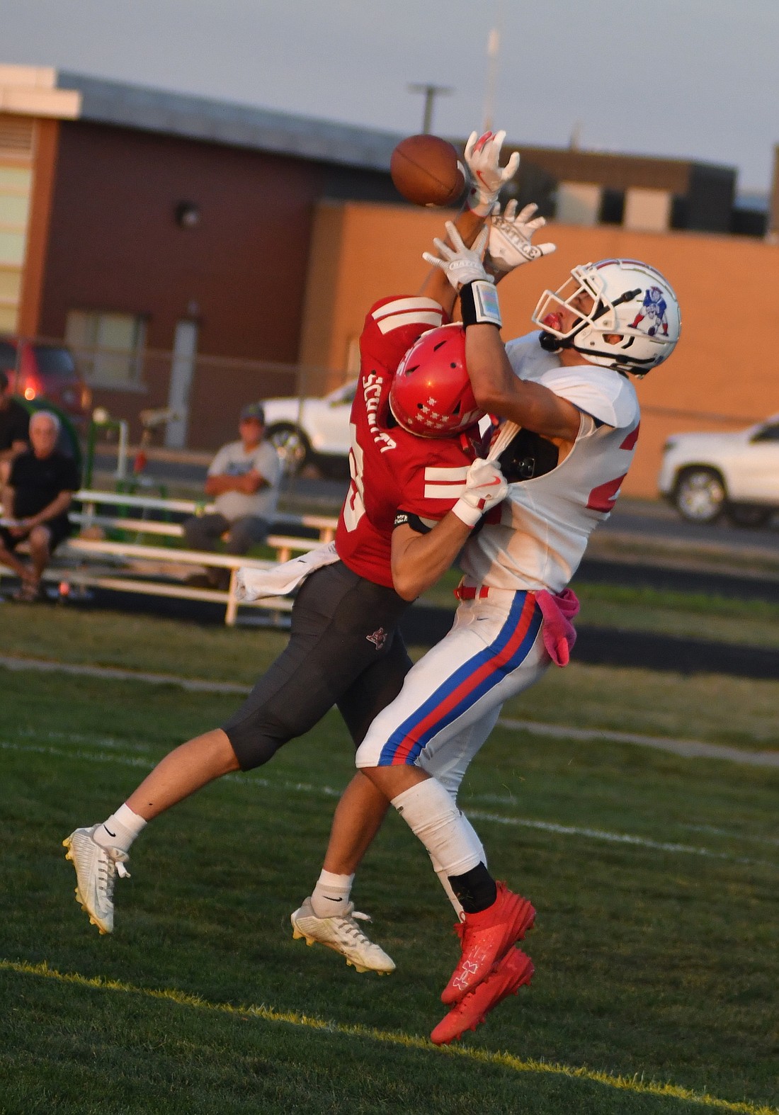 Jay County High School’s Benson Ward goes up to try and catch a ball with Adams Central’s Carson Schnitz draped over him in coverage. The Patriots fell to the Jets 39-8 on Friday. (The Commercial Review/Andrew Balko)