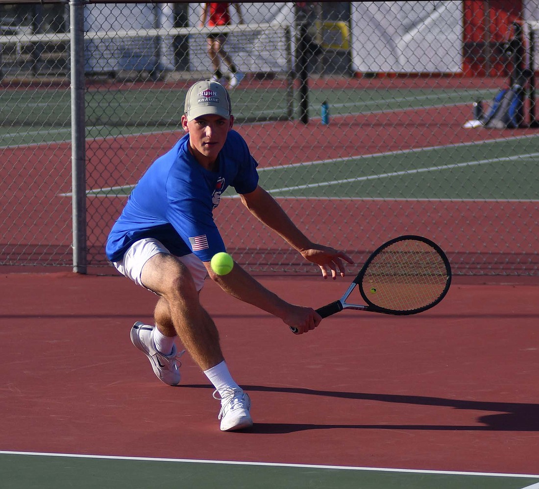 Jay County High School senior Eli Dirksen runs up to backhand a ball during the No. 1 singles match on Monday at Blackford. Dirksen made quick work of Trenton Norton for a 6-1, 6-0 triumph to give JCHS its first point. (The Commercial Review/Andrew Balko)