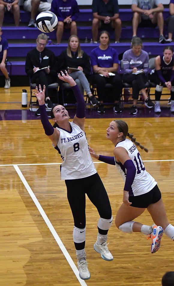 FRHS setter Kayla Heitkamp sets a ball as Karlie Niekamp slides over during the second set on Tuesday. Heitkamp assisted hitters 25 times in the win over Minster. (The Commercial Review/Andrew Balko)