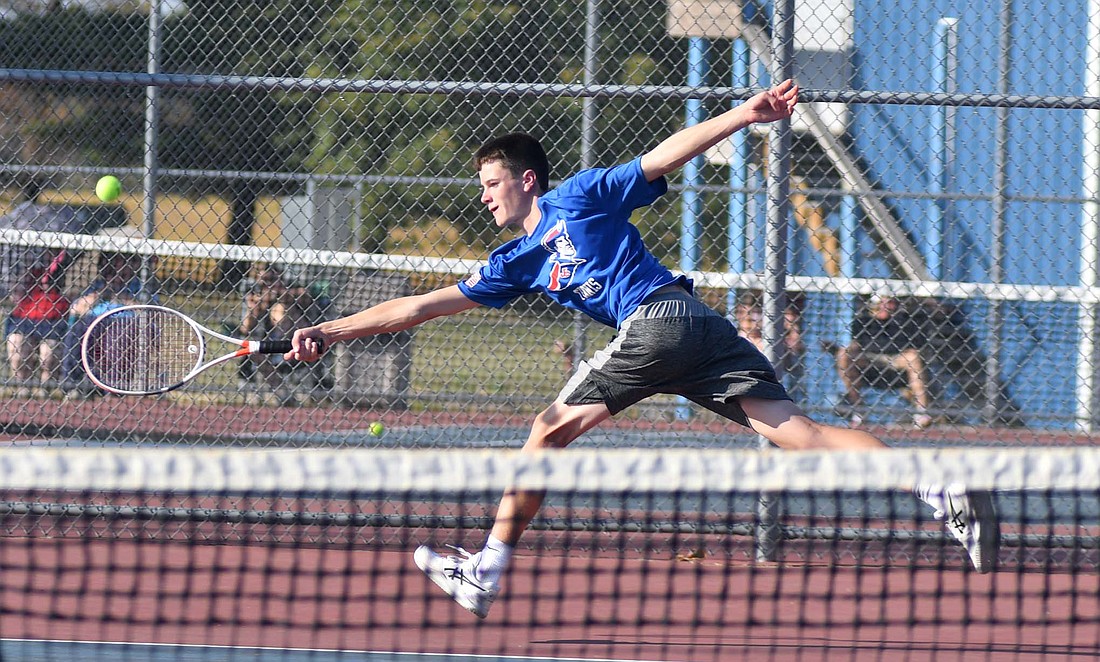 Alex Miller, a freshman doubles player on the Jay County High School boys tennis team, stretches to reach a well-placed shot from the Winchester No. 1 doubles team on Thursday. Miller and Kadyn Carpenter fell to the Golden Falcons’ Foster Kratoska and Aiden Menedenhall 6-3, 2-6, 6-2, but the Patriots still managed a 3-2 win in the match. (The Commercial Review/Andrew Balko)