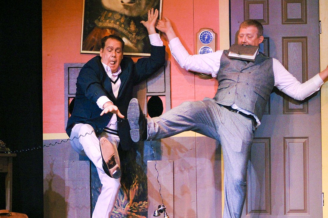 Jay County Civic Theatre members Ric VanSkyock and Chad Mills hold the set of “The Play That Goes Wrong” together as VanSkyock reaches for a telephone prop Tuesday during dress rehearsal at Arts Place. Shows for Jay County Civic Theatre’s production of the slapstick comedy are slated for 7 p.m. Friday and Saturday and 2 p.m. Sunday. (The Commercial Review/Bailey Cline)