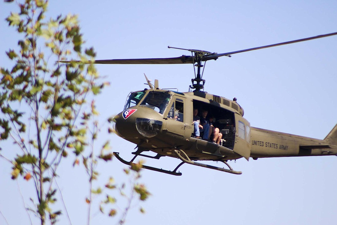 A 1970 United States Army  helicopter prepares for a landing Saturday afternoon at Jay County Fairgrounds in Portland during the Indiana Military Vehicle Preservation Association’s Military Vehicle Show and Swap Meet. Attendees could purchase tickets to ride on the aircraft provided by Columbus Indiana Huey. (The Commercial Review/Bailey Cline)