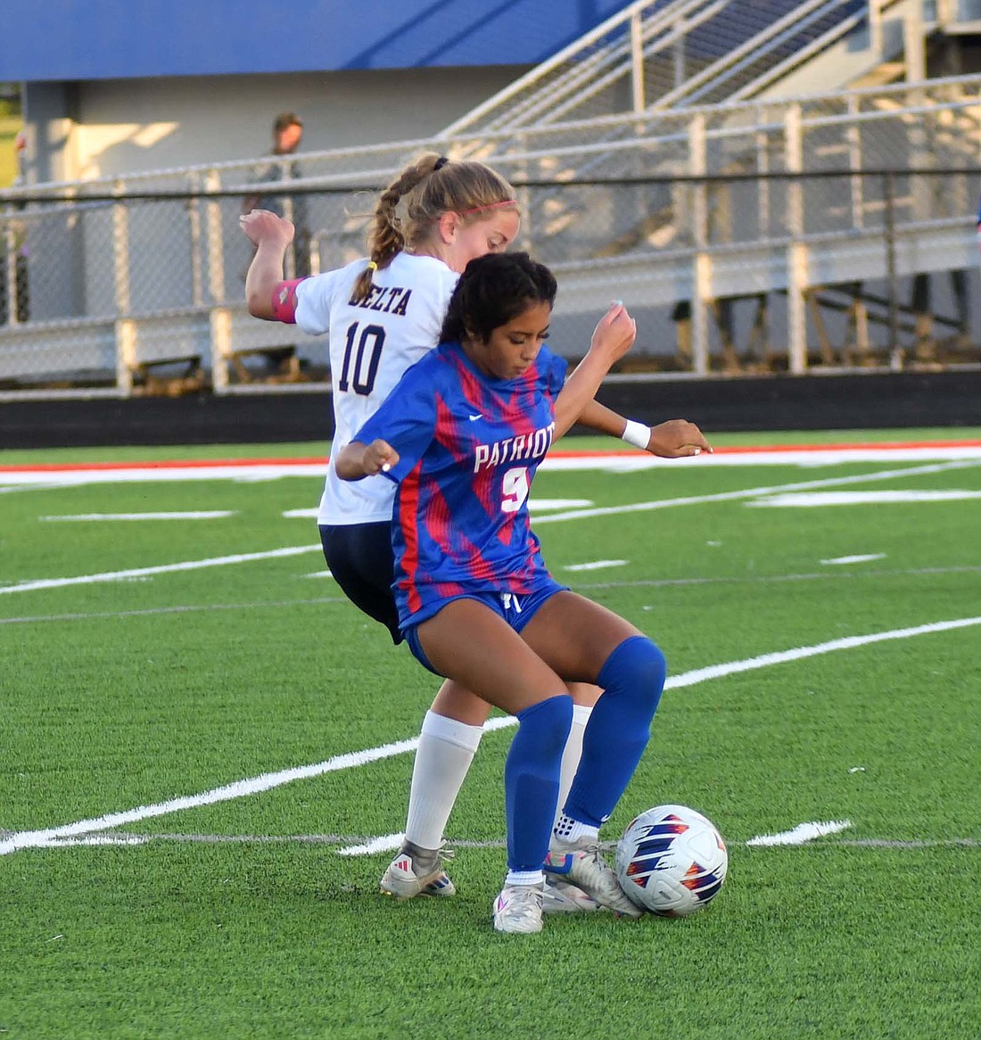 Jay County High School junior Aixa Lopez uses her body to shield the ball away from Delta’s Jordan Bunch on Tuesday. Bunch scored a goal and assisted another in the Eagles’ 2-0 win over the Patriots. (The Commercial Review/Andrew Balko)