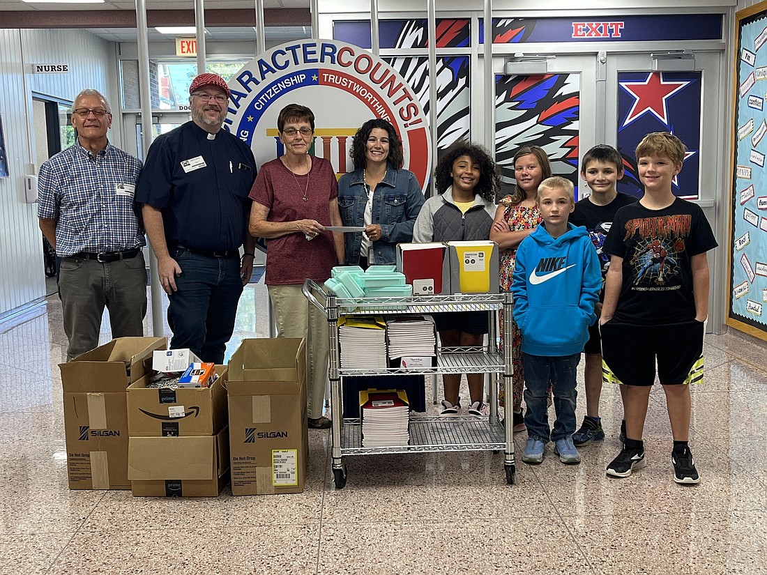 Asbury United Methodist Church recently donated to East Jay Elementary School in honor of Lee Newman, who was principal at what was then East Jay Middle School for 13 years and was vice chair of the church council at the time of his death in November. The church provided school supplies and $1,000 to reduce school lunch debt. The church raised funds via a fish fry last month. Pictured, from left, are Brad Glentzer, Pastor Joe Boggs and Newman’s wife Sharon, East Jay principal Erica Tomano and students Adrionna Justice, Tasha Campbell, Sabastian Herriford, Keenan Osterholt and Remington Humphrey. (The Commercial Review/Ray Cooney)