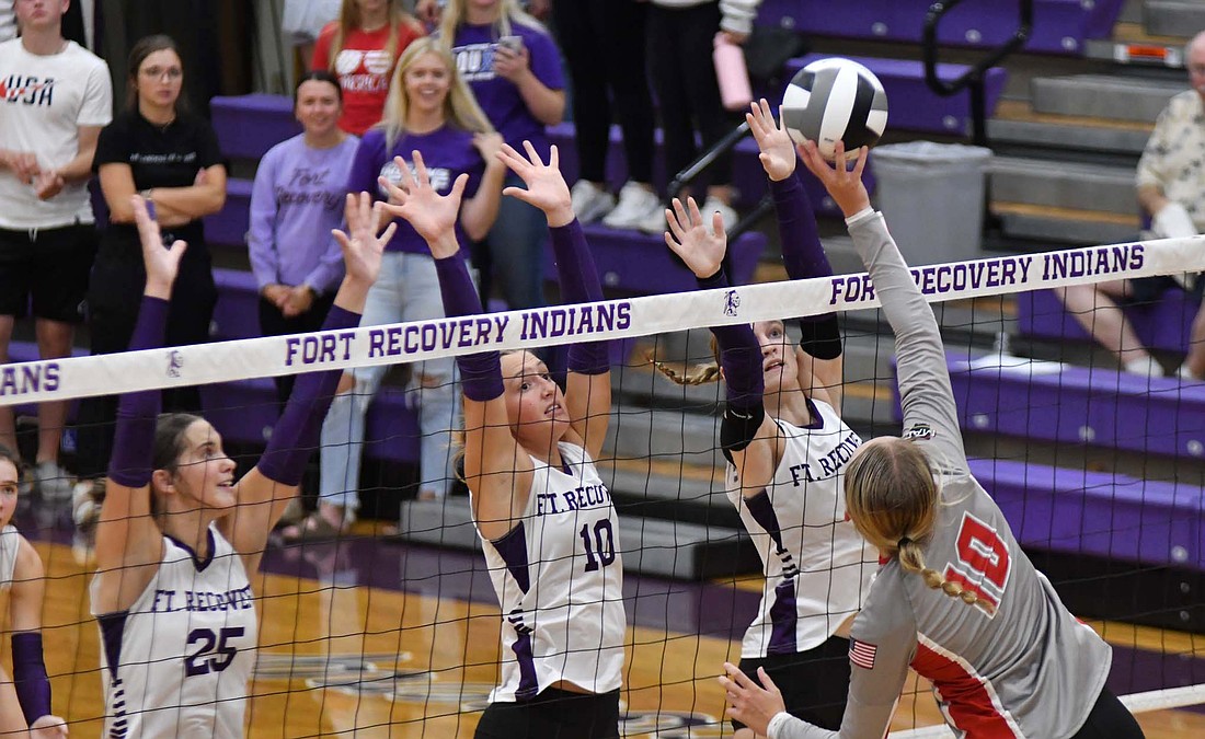 New Knoxville’s Brynn Egbert directs a tip to the right as the Fort Recovery High School volleyball team’s front row players — Bridget Homan (25), Karlie Niekamp (10) and Kennedy Muhlenkamp (11) — meet her at the net on Thursday. Egbert led all hitters with 18 kills as her Rangers handed FRHS 25-23, 25-19, 25-22 loss. (The Commercial Review/Andrew Balko)