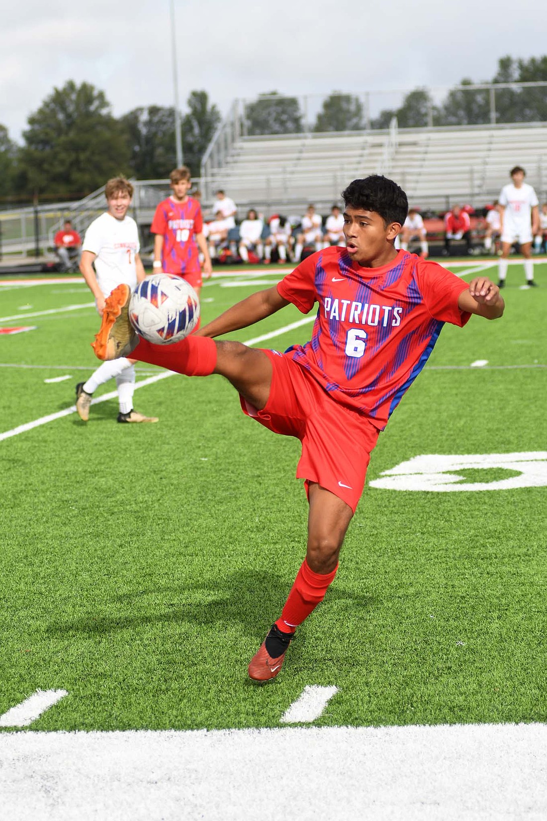 Dylan Marentes, a senior at Jay County High School, stretches to control a ball during the Patriots’ 4-3 win over Connersville Saturday. Marentes assisted the winning goal. (The Commercial Review/Andrew Balko)