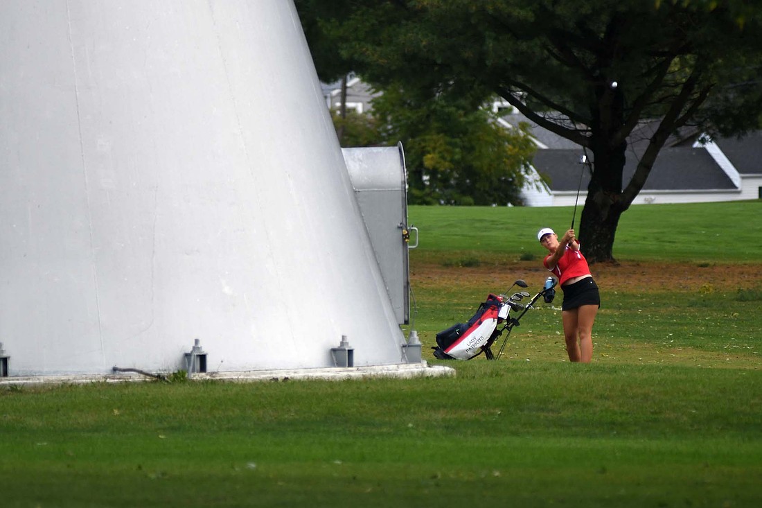 Jay County High School senior Maddy Snow plays back onto the fairway from behind a water tower on the first hole at Edgewood Golf Club on Saturday. She saved the hole for a bogey en route to a round of 100. (The Commercial Review/Ray Cooney)