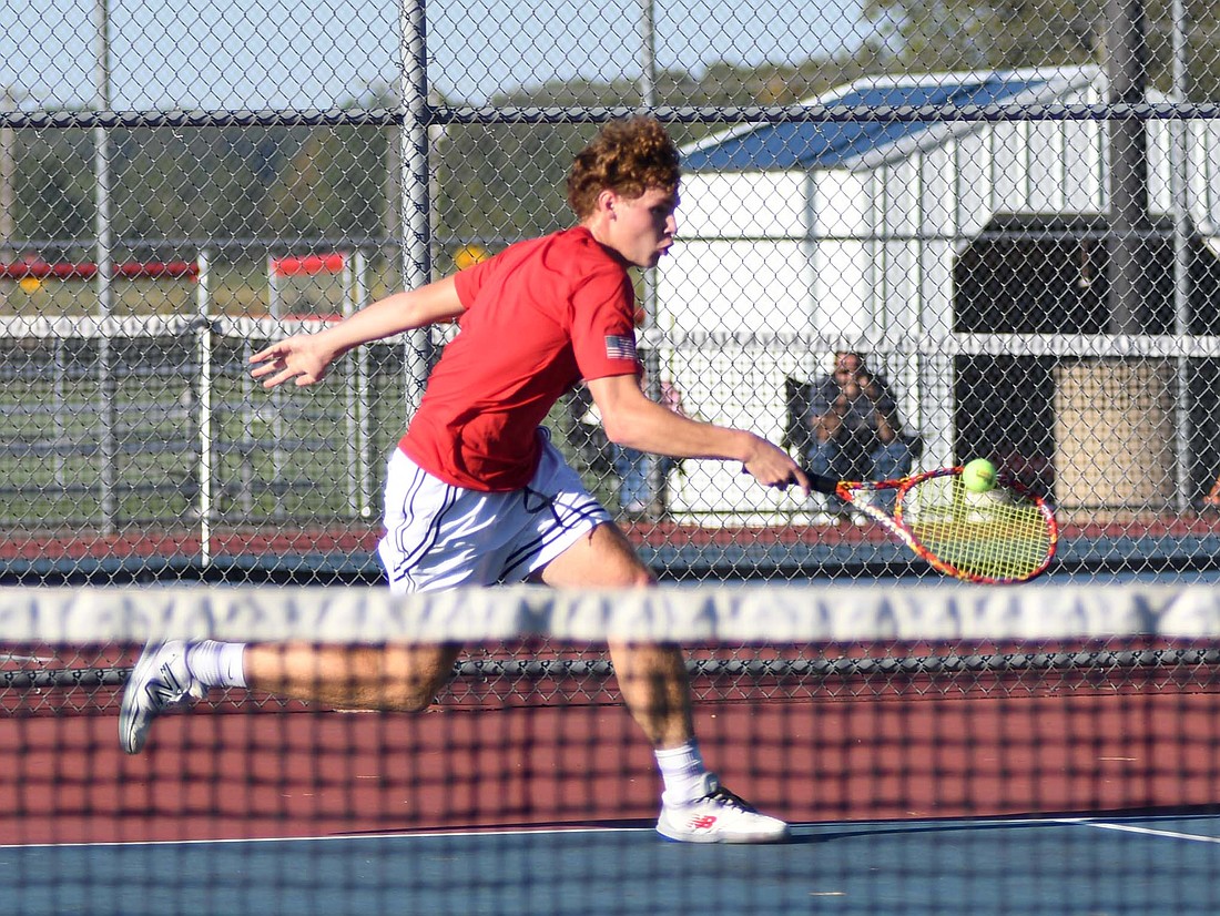 Jay County High School senior Tucker Griffin hits a one-handed backhand on the move during the IHSAA Sectional 53 opener against Randolph Southern. Griffin got revenge on the Rebels’Braden Austin for a 6-1, 6-1 victory that helped the Patriots sweep. (The Commercial Review/Andrew Balko)