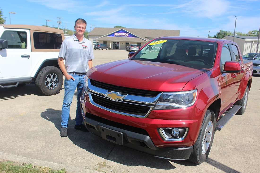 Patriot Auto Sales and Service, a car maintenance and repair shop that opened earlier this year in Portland, recently started offering used vehicles for sale. Pictured above, general manager Zach Fullenkamp stands with a 2017 Chevrolet truck for sale in September at the business, 1509 N. Meridian St., Portland. (The Commercial Review/Bailey Cline)