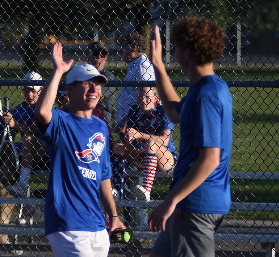 Jay County High School seniors Gabe Pinkerton (left) and Tucker Griffin high five following the Patriots’ 3-2 victory over Union City to claim their third consecutive sectional championship on Thursday. (The Commercial Review/Andrew Balko)