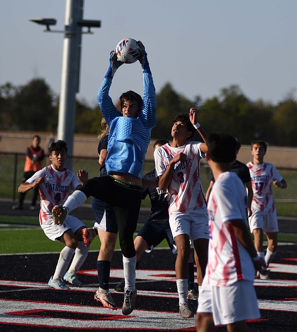 Jay County High School’s Peyton Yowell jumps up to snag a corner kick on Wednesday’s sectional semifinal match against Delta at Eastbrook. The goalkeeper made 10 saves in the game, while also getting help at the goal line with saves by Aryan Montes and Ashton Castillo. (The Commercial Review/Andrew Balko)