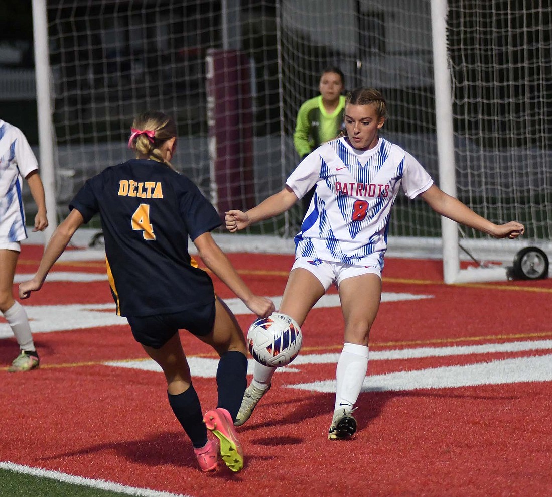 Jay County High School’s Ariel Beiswanger makes a defensive stand against Chloe Newsome of Delta during the IHSAA Class 2A Sectional 24 semifinal game at Mississinewa on Thursday. The Patriots’s season ended with a 3-1 loss to the Eagles. (The Commercial Review/Andrew Balko)