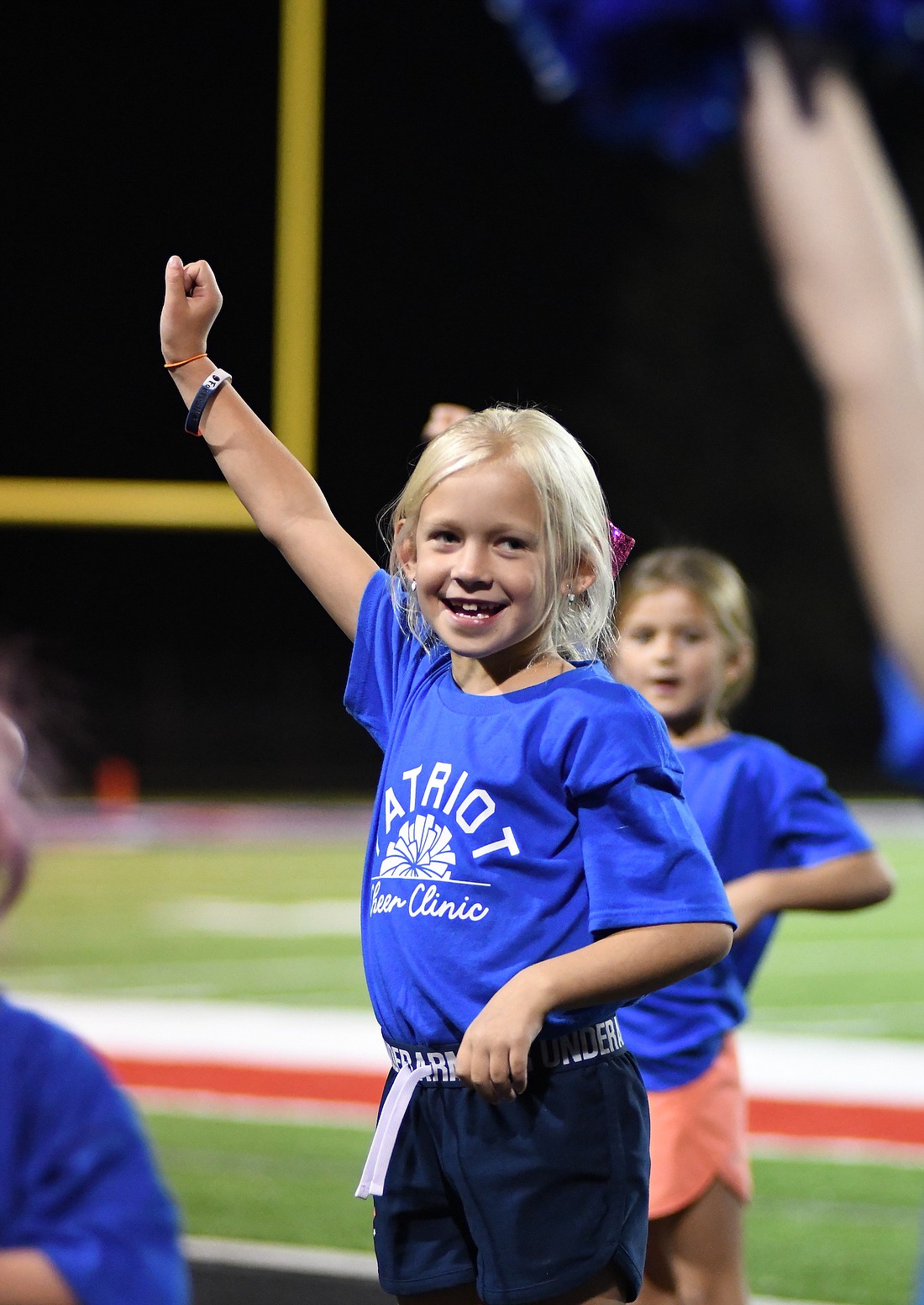 Harper Wendel cheers during halftime of Friday night’s Jay County High School football game against the Lapel Bulldogs. She was one of 98 girls who attended the JCHS cheerleading clinic this week and then joined the Patriot cheerleaders on the track at halftime Friday. For more on the game, see page 10. (The Commercial Review/Ray Cooney)