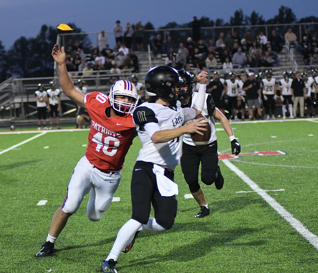 Jay County High School senior Isaac Dues chases down Lapel quarterback Devin Craig during the first half Friday night. Dues had three sacks as the Patriot defense limited the visiting Bulldogs to 138 yards, but JCHS still fell to a 14-12 defeat. (The Commercial Review/Ray Cooney)