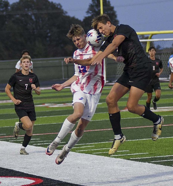 Jay County High School’s Blake Collins battles with Eastbrook’s Graeson Secrest to win a header during the IHSAA Class 2A Sectional 23 championship on Saturday. The Patriots claimed their second title in three years after nailing 4-of-5 penalty kicks. (The Commercial Review/Ray Cooney)