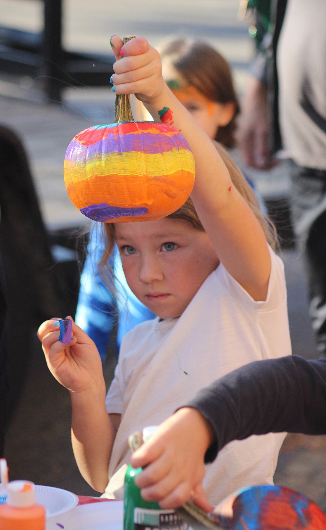 Bristol Bruggeman, 6, paints a pumpkin Thursday at Jay County Public Library during its Fall into Fun event. The partnership with Jay County Farm Bureau offered pumpkin picking and painting, fall crafts, wagon rides, outdoor games and inflatables, as well as hot chocolate, apple cider and other snacks. (The Commercial Review/Bailey Cline)