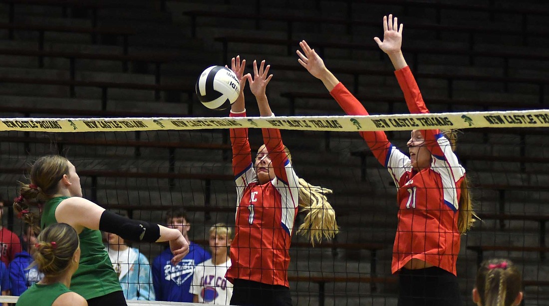 Jay County High School’s Hallie Schwieterman (1) and Mya Kunkler (11) go up for a block during the IHSAA Class 3A Sectional 24 final at New Castle on Saturday. Schwieterman provided a spark in the third set with two early kills. (The Commerical Review/Andrew Balko)