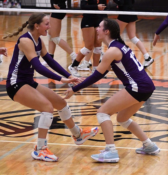 Karlie Niekamp (left) of the Fort Recovery High School volleyball team races over to celebrate with Cameron Muhlenkamp after the Indians took down the host Arcanum Trojans 25-17, 25-18, 25-20 in the OHSAA Division VI Southwest 2 district semifinal Wednesday. FRHS will face Miami Valley Christian Academy on Saturday with a trip to the regional on the line. (The Commercial Review/Andrew Balko)