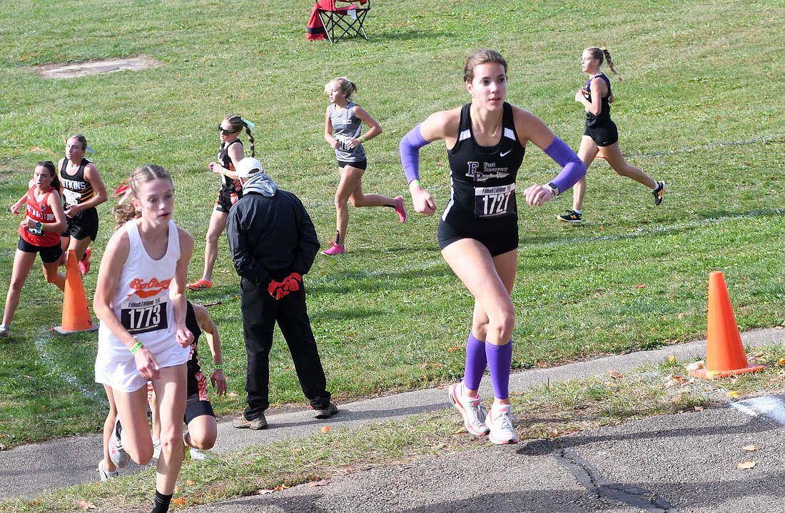 Fort Recovery High School senior Joelle Kaup keeps pace with West Liberty-Salem’s Isla Leichty while running up a steep hill at the two-mile mark of the OHSAA Division III Southwest Regional 12  cross country meet at Troy on Saturday. Kaup’s time of 21 minutes, 6.73 seconds, left her 42.07 seconds short of a state berth. (The Commercial Review/Andrew Balko)