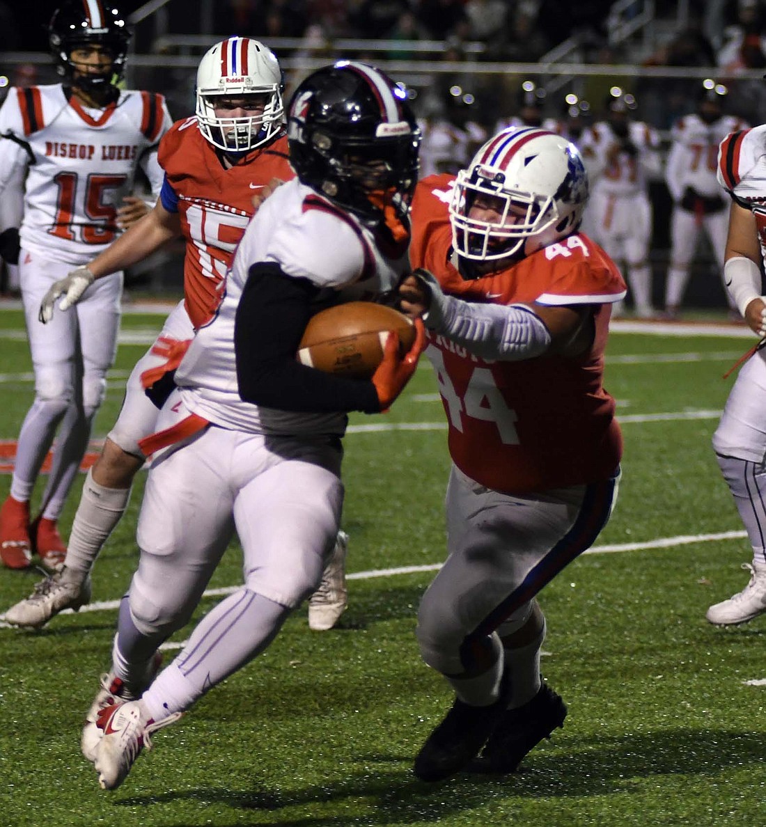 Jay County High School’s Austin Schoenline looks to wrap up Daryea Williams during the sectional final game that the Patriots dropped 41-8 on Friday. While Schoenline didn’t manage the tackle, he slowed Williams down enough for Garrett Bennett to come in and complete the stop. (The Commercial Review/Andrew Balko)