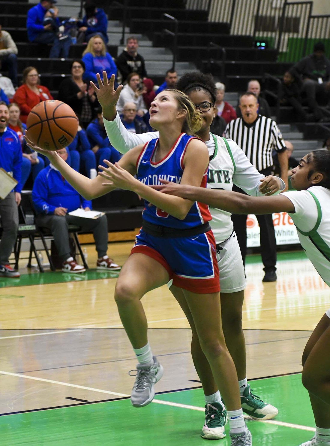 Alexis Sibray, one of two juniors on the Jay County High School girls basketball team, gets fouled by Amayia Shetler of South Side in the season opening victory on Tuesday. Sibray finished with five rebounds, three points and one assist in the 60-40 triumph. (The Commercial Review/Andrew Balko)