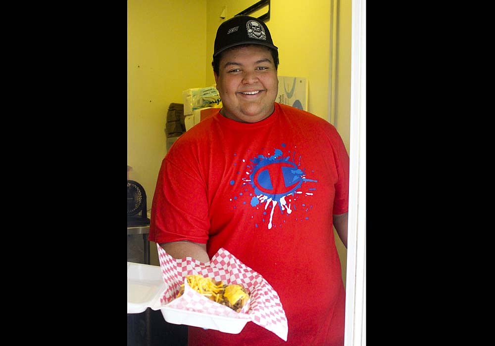 Sean Guntle, pictured above, opened Big Sean’s Dawgs in Portland in late summer. The establishment offers specialty hot dogs and nachos from its spot at the southwest corner of the Commerce Street and Walnut Street intersection. (The Commercial Review/Bailey Cline)