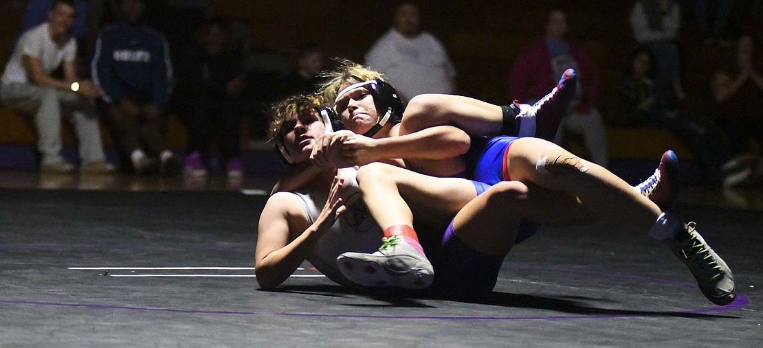 Jay County High School freshman Brenna Ruble runs a far side cradle on Muncie Central’s Courtney Thrash during a dual-meet on Thursday. Ruble pinned Thrash with the move a little over two minutes into the match, to help the Patriots to a 54-15 victory and keep Ruble undefeated on the year. (The Commercial Review/Andrew Balko)