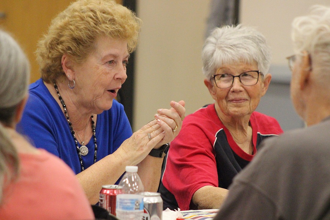 Judy Alig (left) of rural Bryant chats with rural Portland resident Linda Deaton and others during the Thanksgiving carry-in Tuesday at Jay Community Center. (The Commercial Review/Bailey Cline)