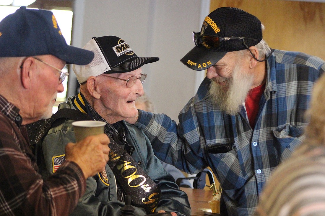 Herb Heston (center) chats with Phillip Roy on Tuesday amid his birthday celebration at The Waters of Dunkirk. Heston turned 100 years old this week. Herb is a World War II veteran, having served under Gen. George Patton. (The Commercial Review/Bailey Cline)