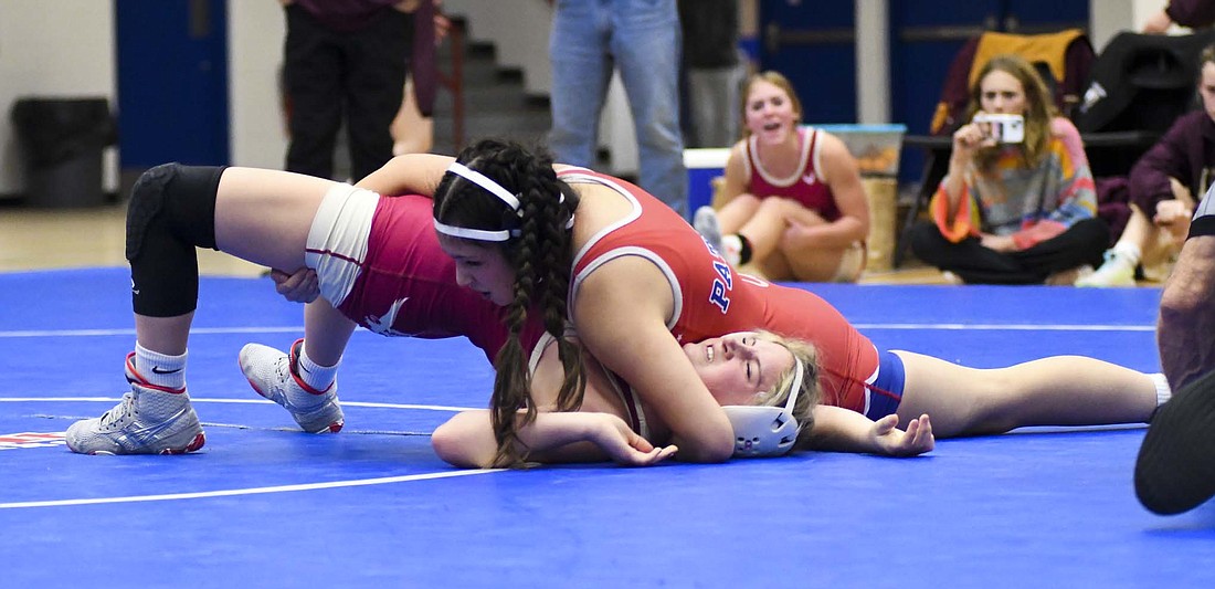 Jay County High School sophomore Sophia Thomas runs a half nelson on Columbia City’s Alexa LaFever, eventually leading to the pin on Thursday. Thomas secured her third career victory by fall over LaFever to help the Patriots get past the Eagles 60-12. (The Commercial Review/Andrew Balko)