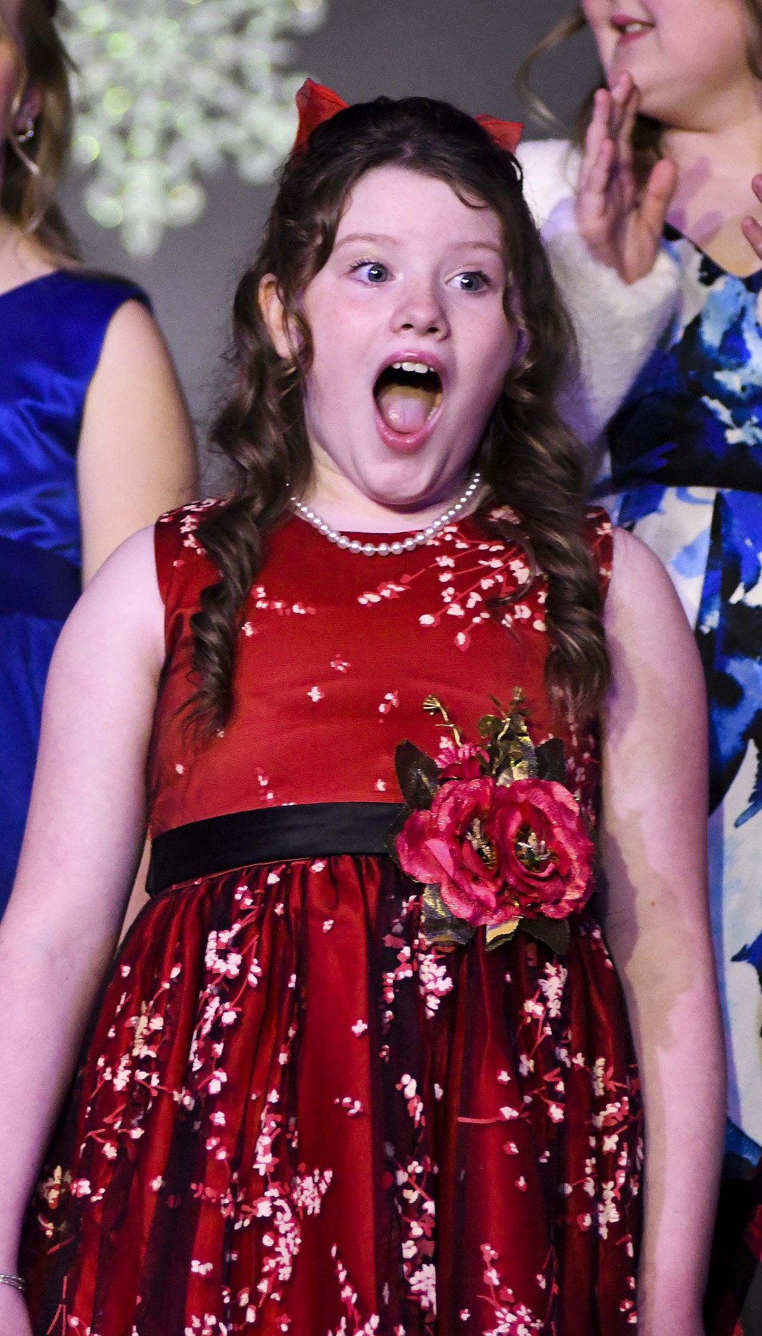 Winterfest events Saturday including the Little Miss Winterfest Pageant at Fellowship Baptist Church and the Parade of Lights through downtown Portland. Pictured above, Niyah McIver reacts after being announced as the first runner-up in the pageant. She now has a matching sash with her sister Inara Sanderson, who was the runner-up in this year’s Miss Jay County Fair Queen Pageant. Below, Parade of Lights participants smile and wave to the crowd gathered at the intersection of Main and Meridian streets. (The Commercial Review/Ray Cooney)