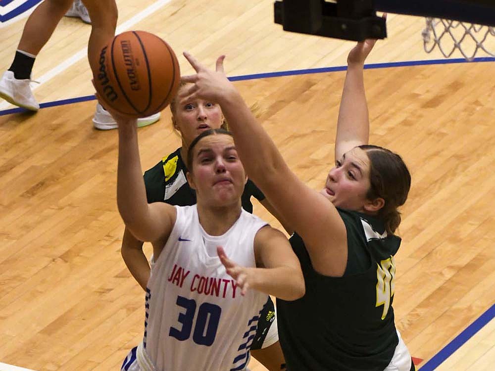 Jay County High School freshman Elizabeth Brunswick goes up for a layup while Northeastern’s Mackenzie Johnson defends during Tuesday’s 60-33 loss. Brunswick finished with a team-high three assists while adding eight points and five rebounds. (The Commercial Review/Andrew Balko)