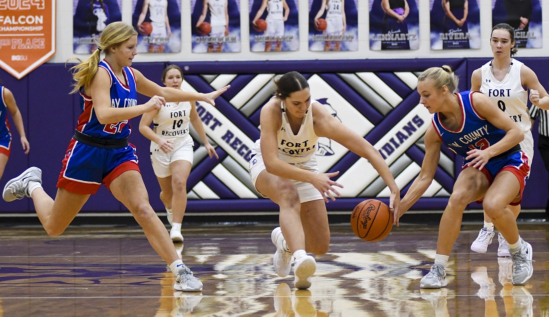 Fort Recovery’s Bridget Homan and Hallie Schwieterman of Jay County fight for a loose ball during the game the Indians won 59-32 on Saturday. (The Commercial Review/Ray Cooney)