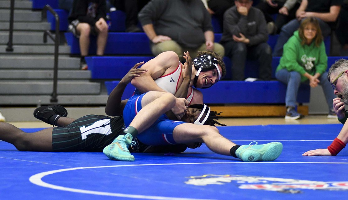 Jay County High School’s Jason Landers gets Izaiah Hudson of Yorktown in a headlock during the 150-pound match in the second round of a double dual on Tuesday. Landers’ pin of Hudson in 3 minutes, 39 seconds marked his second victory of the day, which was only matched by Jacob Robinson and Alan Ortiz. (The Commercial Review/Andrew Balko)