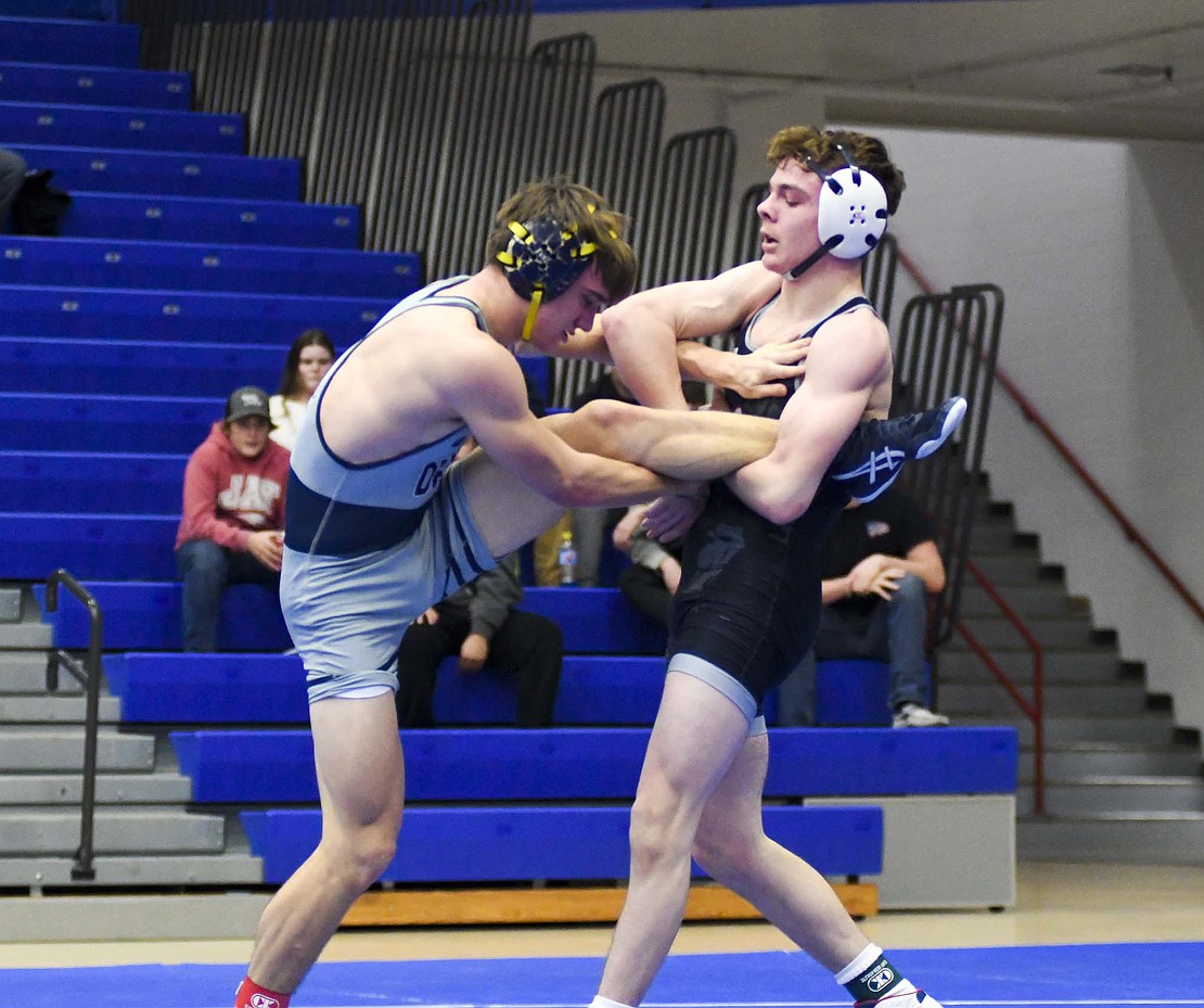 Jacob Robinson works for a single-leg takedown of Delta’s Zeke Witter in the 150-pound contest on Tuesday. Robinson, who went to Delta in middle school and knew Witter, pulled off an 8-6 decision, narrowly avoiding being taken down in the closing seconds of the match. (The Commercial Review/Andrew Balko)