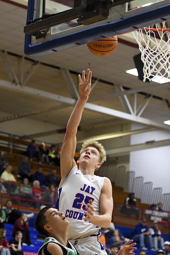 Cole Forthofer, a junior at Jay County High School, puts up a layup during the Patriots’ 58-56 double-overtime victory against New Castle on Saturday. Forthofer scored a team-high 18 points, including seven points in OT and the game-winning put back with just over two seconds remaining. The win was just the third for Jay County in the last 25 matchups against the Trojans. (The Commercial Review/Andrew Balko)