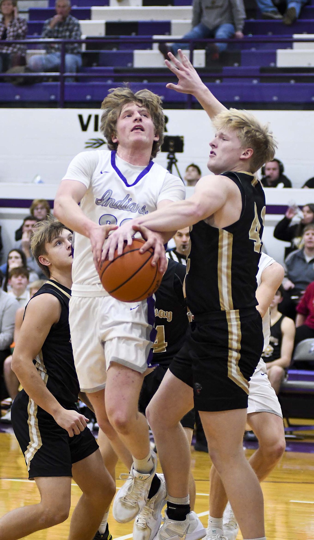 Fort Recovery High School sophomore Grant Fortkamp gets fouled by Ethan Pond of the Parkway Panthers during the first quarter Friday night. Fortkamp scored all of his 10 points in the first half as the Indians went on to pick up their first win of the season, 53-48. (The Commercial Review/Ray Cooney)