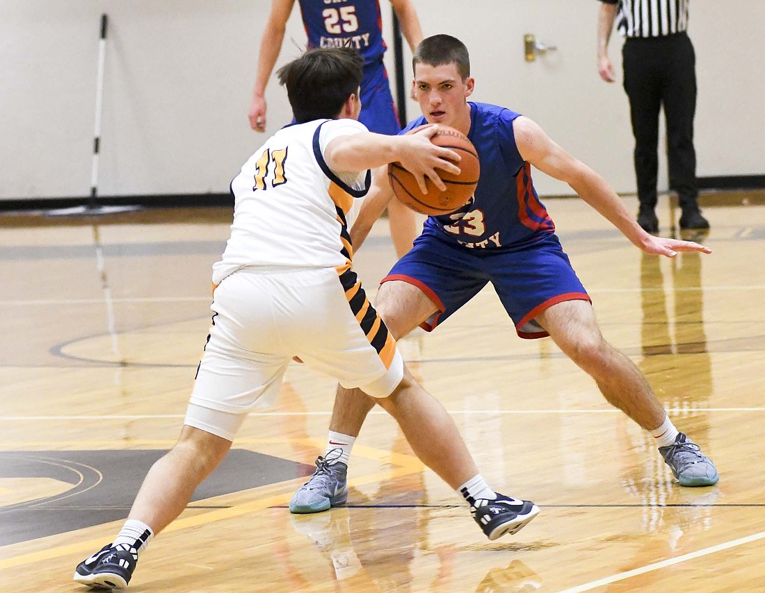 Jay County High School’s Eli Dirksen puts pressure on Delta’s Ryan Lynch during Friday’s 60-44 loss. Dirksen scored six points to start the fourth quarter, but JCHS couldn’t overcome the deficit. (The Commercial Review/Andrew Balko)