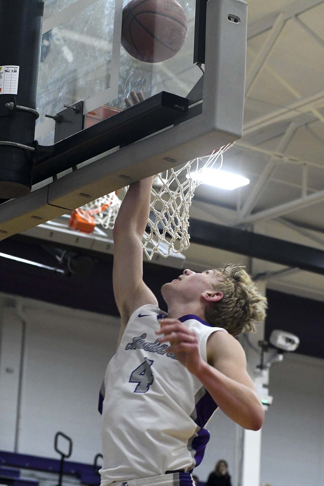 Breaker Jutte, a sophomore on the Fort Recovery High School boys basketball team, smacks the backboard on the follow through of a layup during Saturday’s 82-50 win over Ansonia. Jutte led all scorers with 23 points in the Tribe’s second win of the season. (The Commercial Review/Andrew Balko)