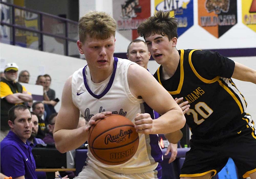 Gavin Evers of the Fort Recovery High School boys basketball team drives past South Adams’ Tytus Lehman in Friday’s 52-42 victory. Evers was fouled on the play and hit down the final two of six consecutive free throws to seal the game. (The Commercial Review/Andrew Balko)